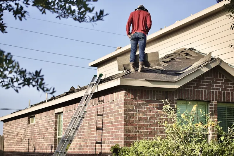 Professional roofer working on a residential roof in Brittany